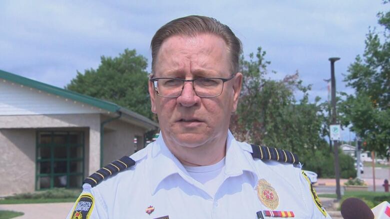 A fire chief is pictured speaking to reporters outside.