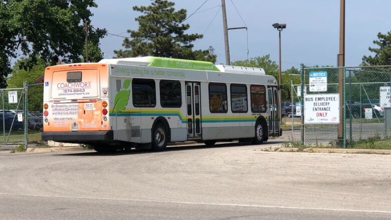 A bus passing through a moving metal gate