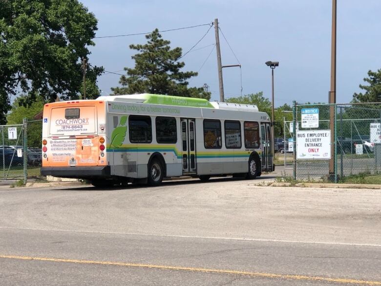 A bus passing through a moving metal gate