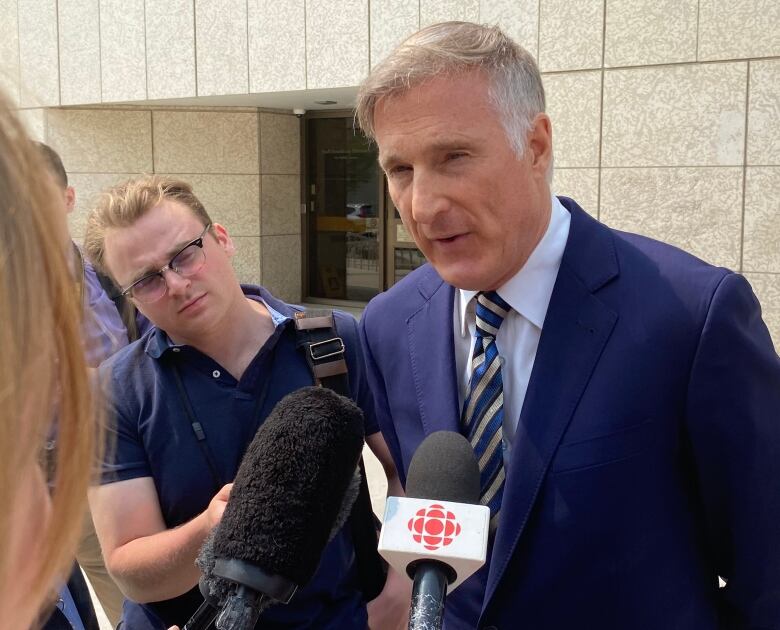 Maxime Bernier is pictured outside a courthouse in Winnipeg.