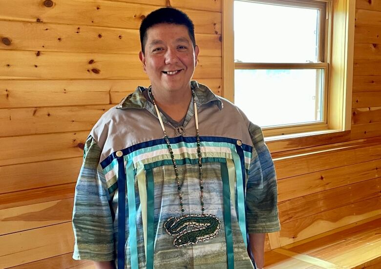 man stands in longhouse