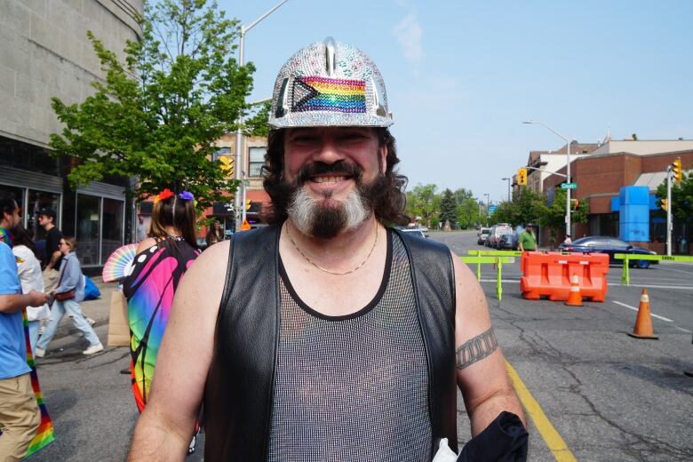 Michel Dumont wearing a black vest, grey top and sparkly helmet.