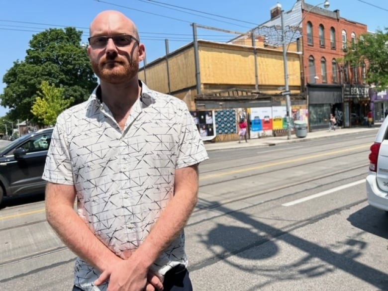 Adam Wynne, a local historian with a special interest in the history of Queen West, stands in front of 520 Queen St. W. as it looks since being rebuilt after the demolition of the original 1850s structure.