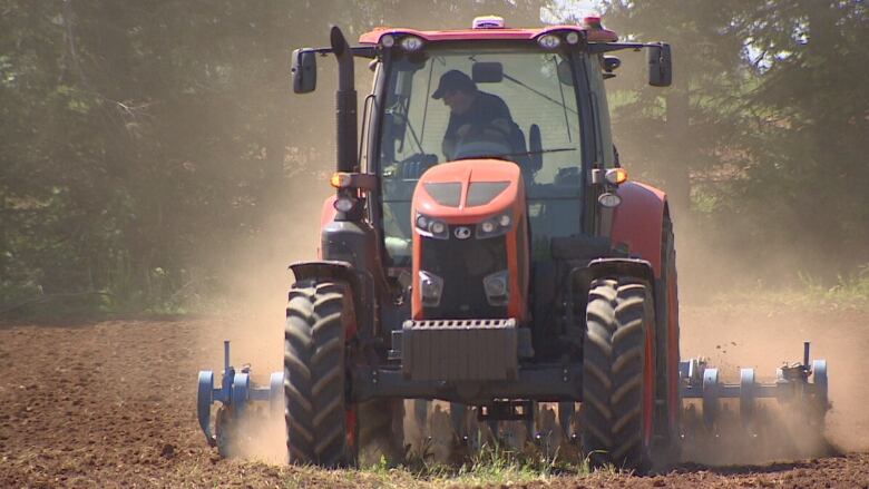 Tractor working soil in Elmwood. 