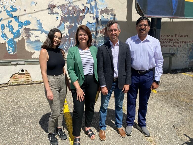 Opposition NDP Leader Carla Beck, second from left, stands with three NDP byelection candidates after a media conference on Friday. The candidates Kaitlyn Stadnyk (far left), Jared Clarke (second from right) and Noor Burki (far right)