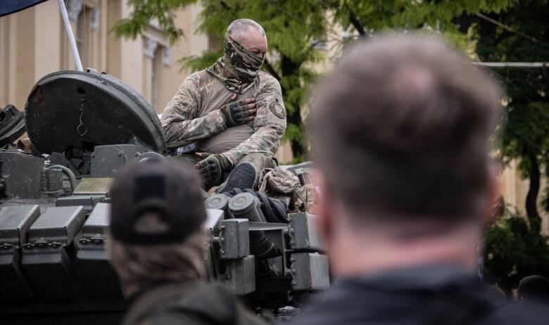 A Wagner group member sits atop of a tank in Rostov-on-Don, Russia. 