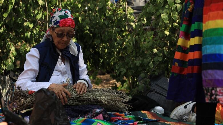 Elder Doreen Moosepayo prepares sage for the ceremony when the placenta of four babies is buried the ground. She explains this is done to  ground the children, so they know who they are. 