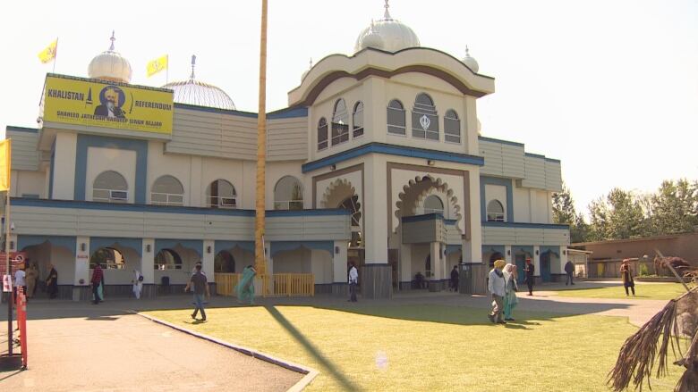 People walk outside a gurdwara.