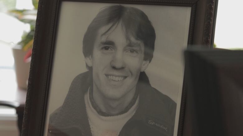 A photograph of Stephen Giffin sits on a table. 