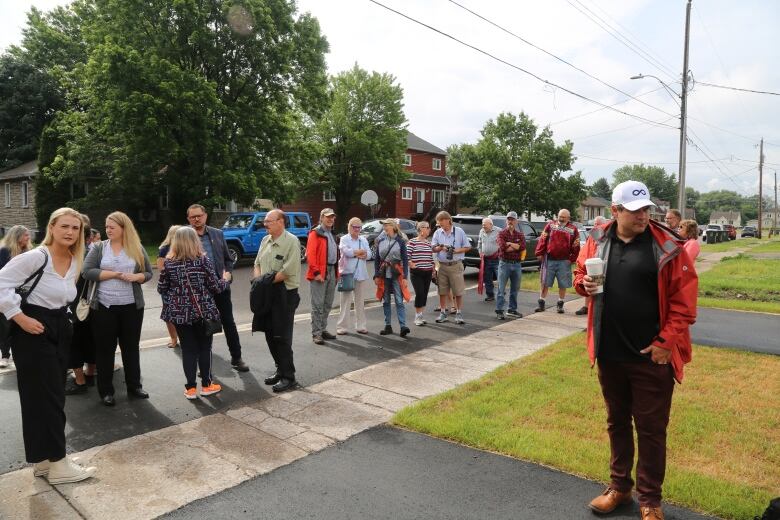 People standing on a sidewalk.