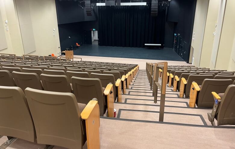 Empty auditorium with hundreds of seats. 