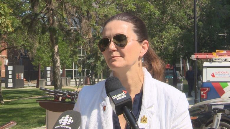 Mayor Sandra Masters is standing with Victoria Park and e-scooters behind her.