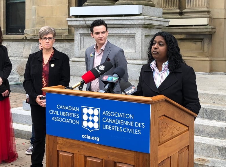 Woman speaking at podium with a sign saying Canadian Civil Liberties Association in front. 