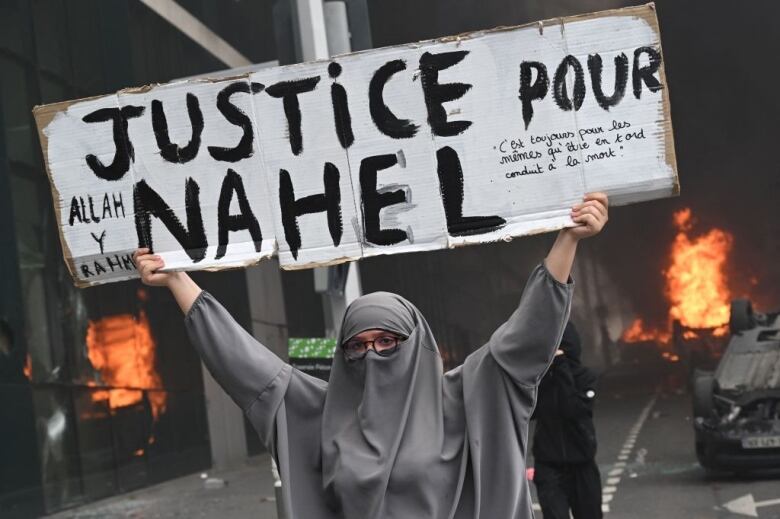 A protester holds a sign.