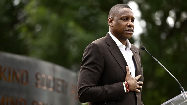 A man speaks at a podium.