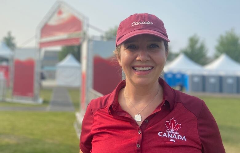 Woman standing at LeBreton Flats with red Canada day shirt and hat on. 