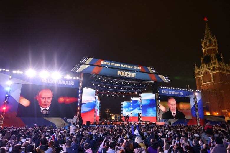 Spectators listen to Russian President Vladimir Putin on Sept. 30, 2022. A concert was held in Moscow's Red Square to celebrate its declared annexation of four Ukrainian regions  September 30, 2022. 