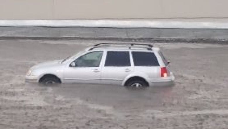 A car caught in a flood on the road