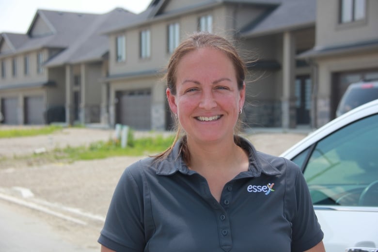 Sherry Bondy, Mayor of Essex stares at the camera in front of a new residential development in Essex.