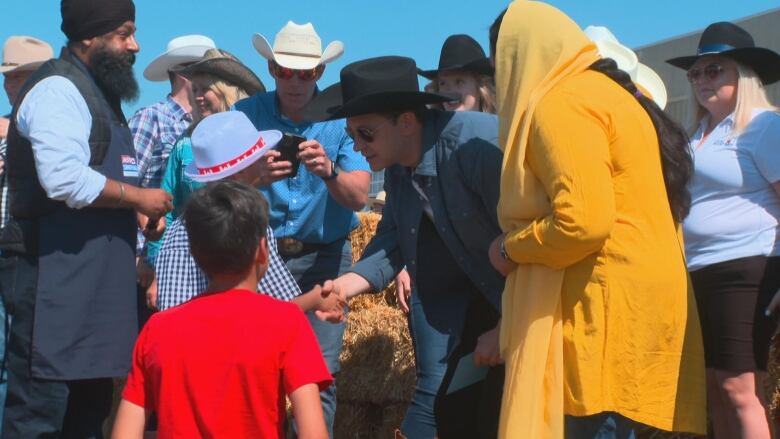 A man shaking hands with a young person.