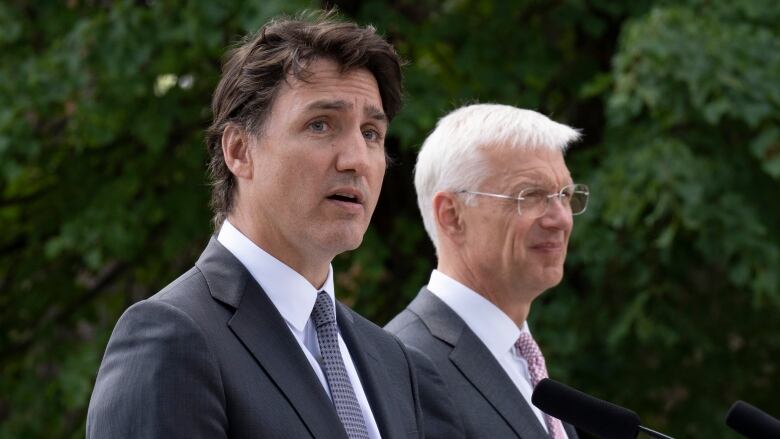 Latvian Prime Minister Krisjanis Karins (right) looks on as Prime Minister Justin Trudeau speaks during a joint media availability at the Adazi Military base on July 10, 2023 in Adazi, Latvia.