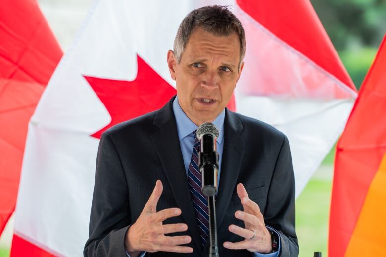 A mayor speaks into a microphone during an announcement.