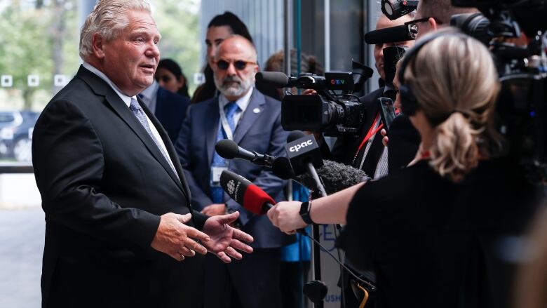 Ontario premier Doug Ford surrounded by cameras at the premier's meeting in Winnipeg. 