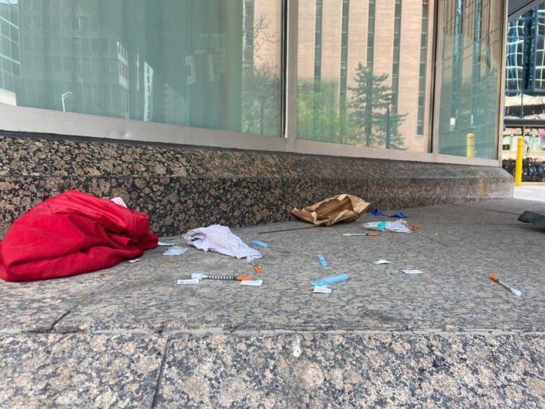 Used needles lay on the ground in downtown Ottawa.