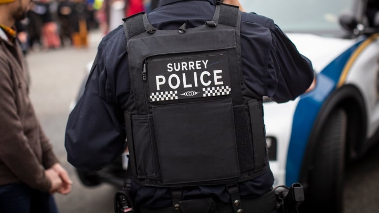 A navy blue police uniform is pictured with the words 