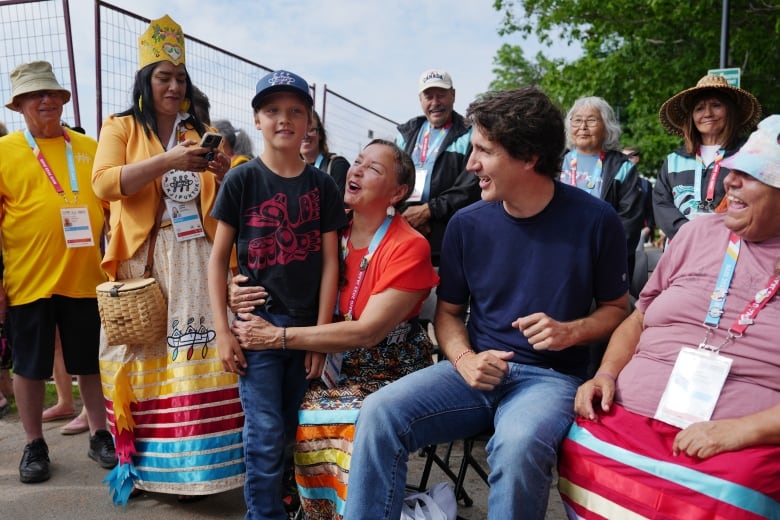 People sit in a group and laugh.