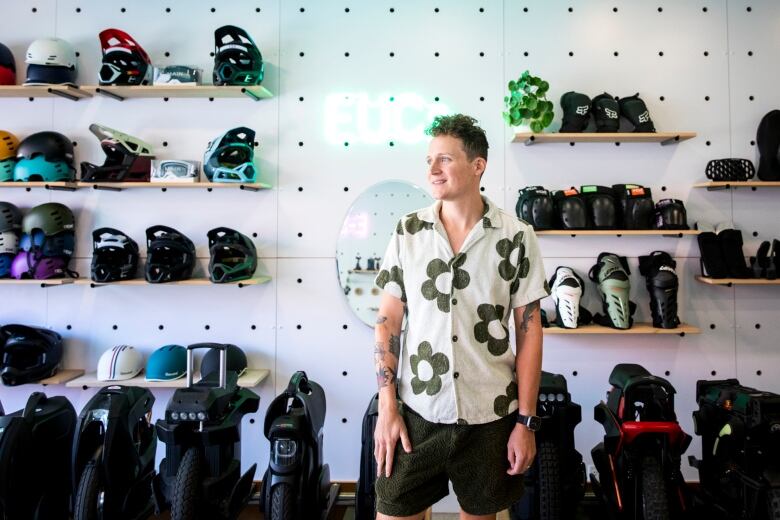 Bradley Spence stands inside of his store, eevee's, which sell personal electric mobility devices.