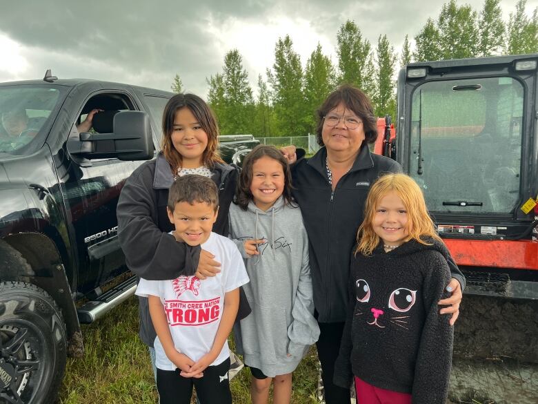 Four children stand with their grandmother.