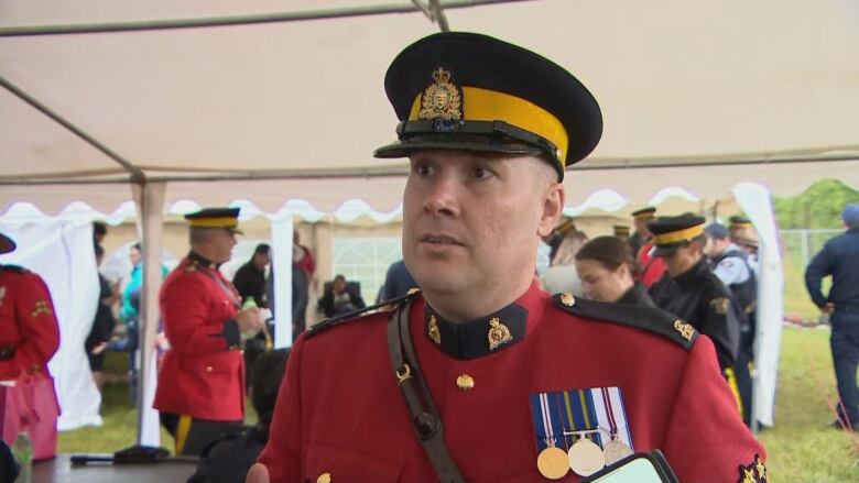 A RCMP officer in red cadet suit.