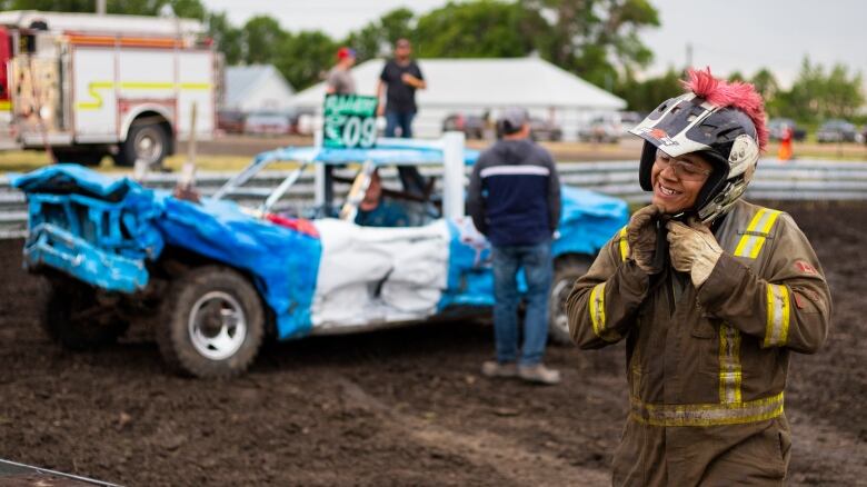 A derby driver takes off his helmet.