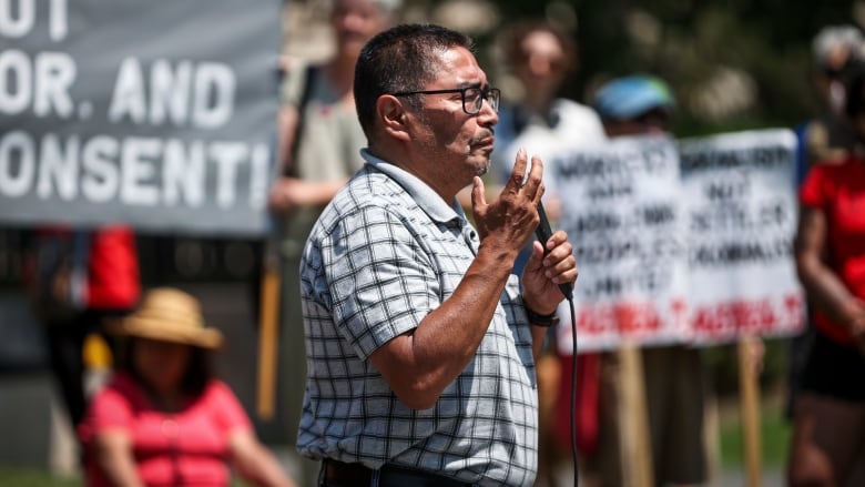 A man speaks into a microphone.