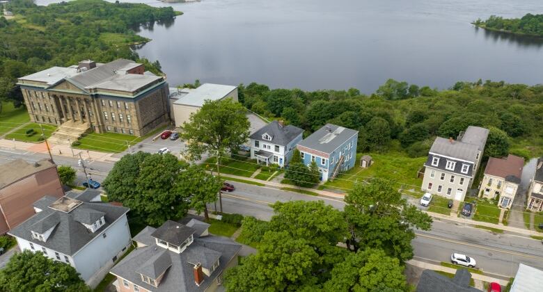 Aerial shot of a city street with the water in the background. 