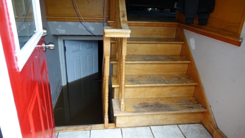 The entryway of a home that shows a flooded basement.