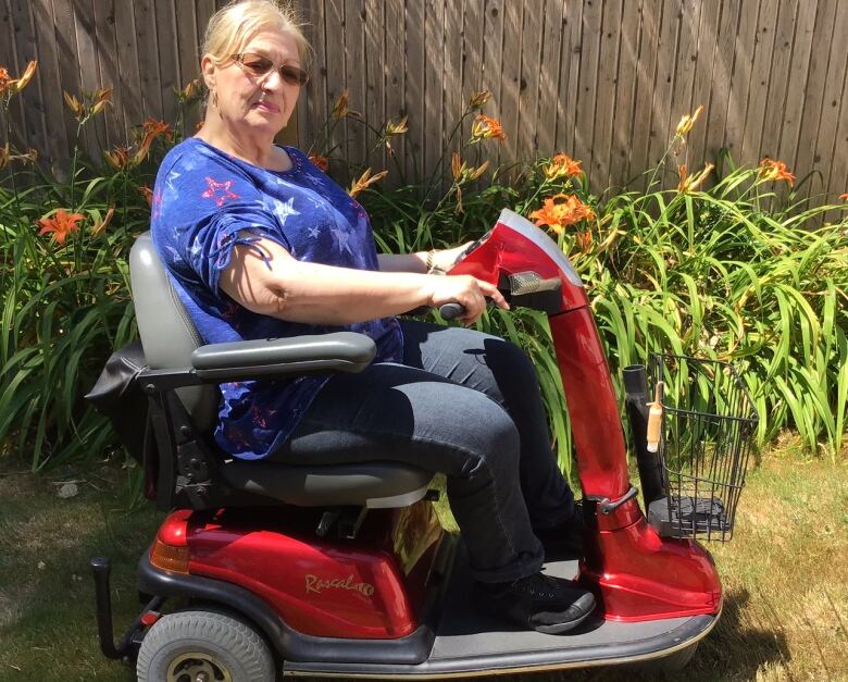 Diane Ray sits on her mobility scooter. 