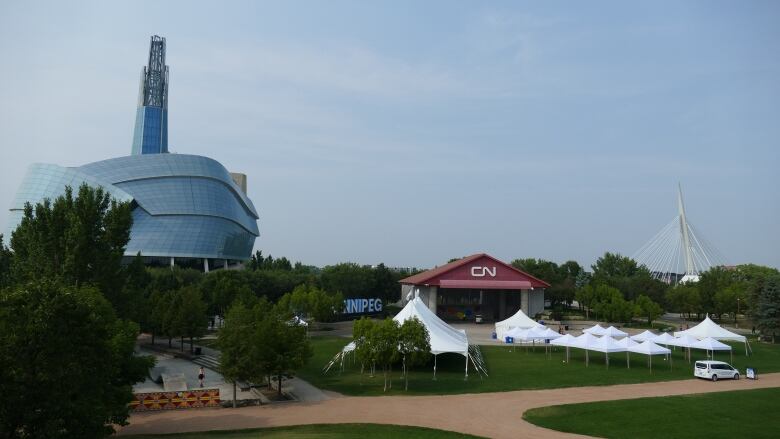 Temporary tents in front of a stage at The Forks.