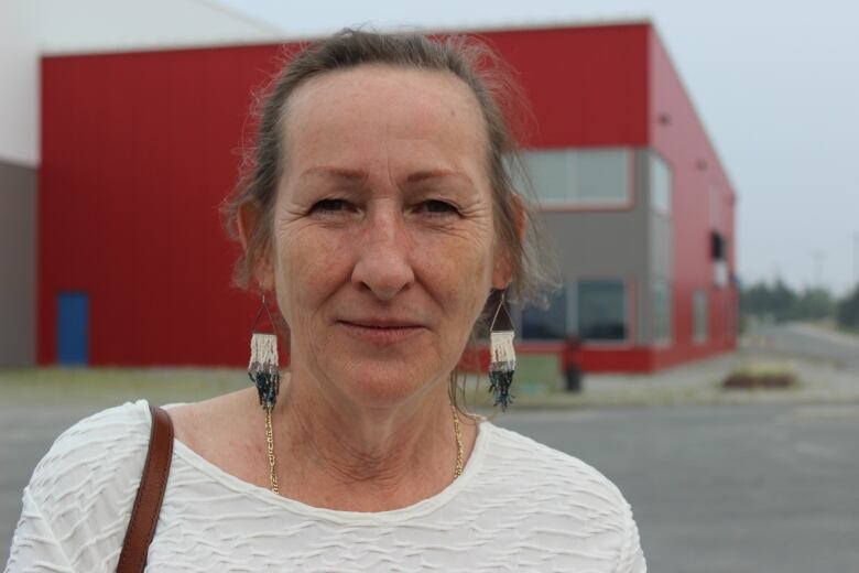 A head shot of a woman outside.