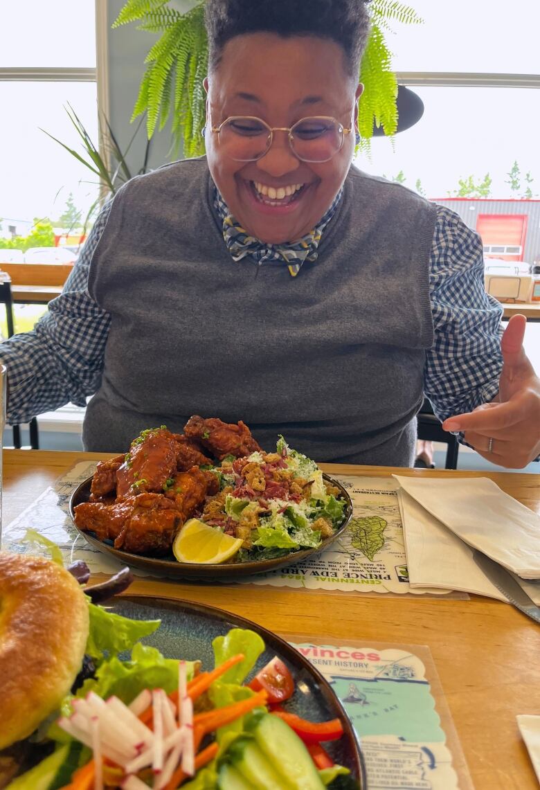 A woman looks lovingly at a plate of food