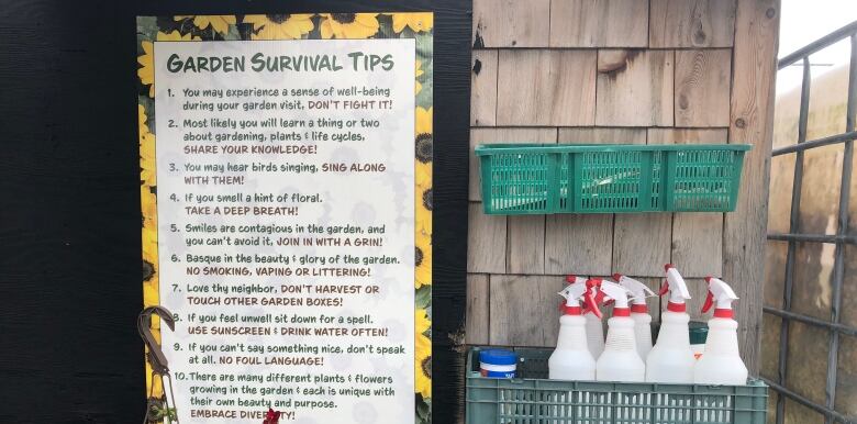 A garden sign with a list of survival tips.