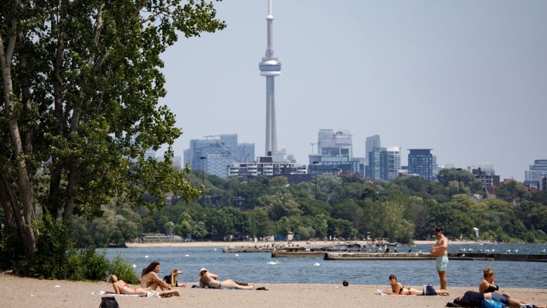 People are photographed during a warm day at Sunnyside Park in Toronto on July 11, 2023.