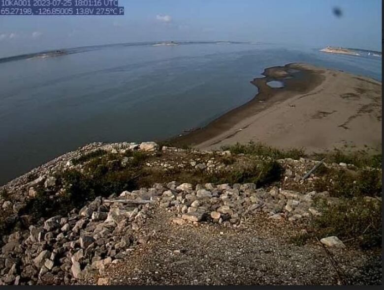 Picture of rock with water around it, higher levels. 