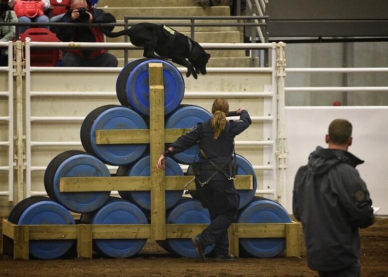 CBSA officers Danielle Getzie and her dog Nova compete in this achieve photo.