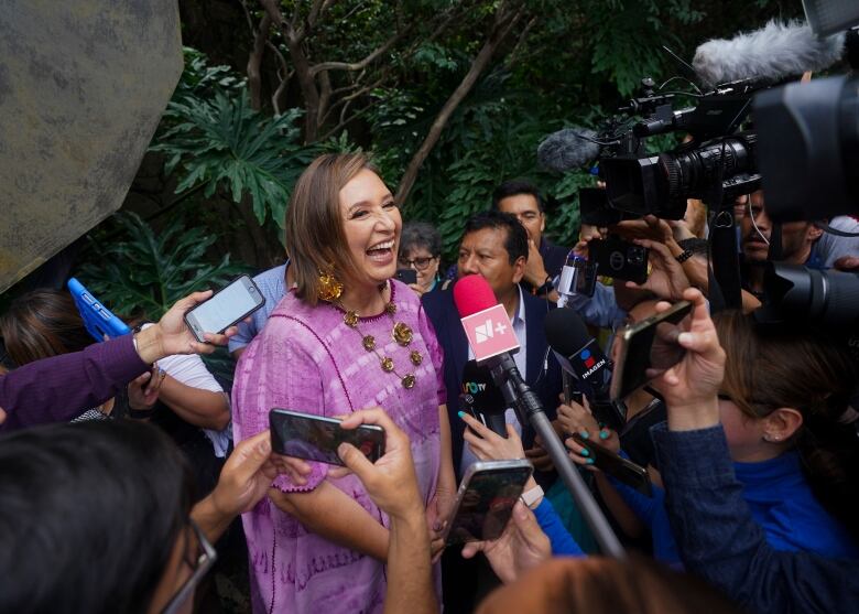 Senator Xochitl Galvez, an opposition presidential hopeful, speaks to the press after registering her name as a candidate in Mexico City, July 4, 2023. The street saleswoman turned tech entrepreneur is shaking up the contest to succeed Mexico's popular president, offering an alternative to Mexican President Andrs Manuel Lpez Obradors dominant party.