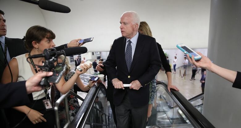 A July 2017 photo shows the late U.S. Senator John McCain talking to reporters in Washington, D.C.