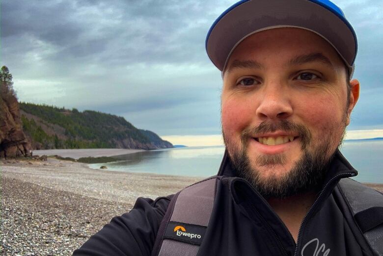 Jeff Clements with DFO on beach, hills in background