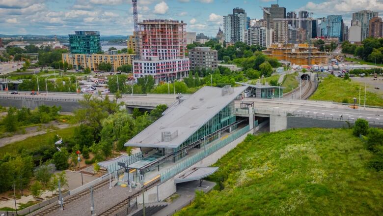 An aerial shot of a light-rail station on a sunny summer day.