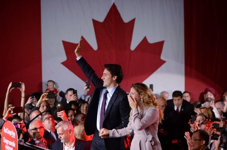 Trudeau makes his way to the stage with Grgoire Trudeau at Liberal party headquarters in Montreal early Tuesday, Oct. 20, 2015.